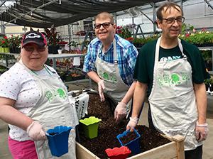 Happy WATCH workers in greenhouse